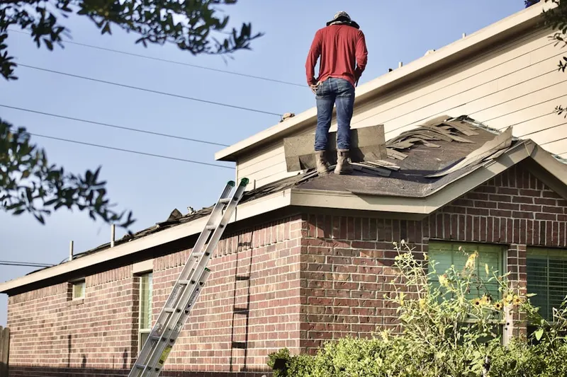 Professional roofer working on a residential roof in Cypress Park